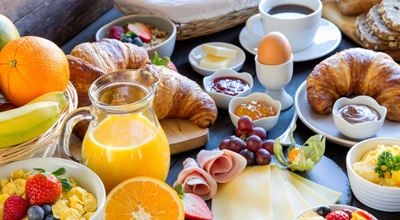 Big breakfast with croissants and orange juice
