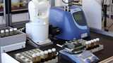 Lab test set up showing fluids and robotic arm