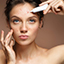 Portrait of woman applying medical paste on acne button 