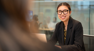 Nouryon employee with black glasses sitting at a desk