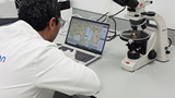 Scientist in laboratory performing oilfield fluid analysis.